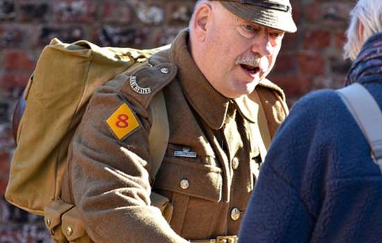 A reanactor dressed in a British First World War uniform.