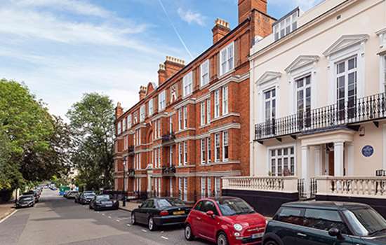 A street of grand terraced houses with large windows