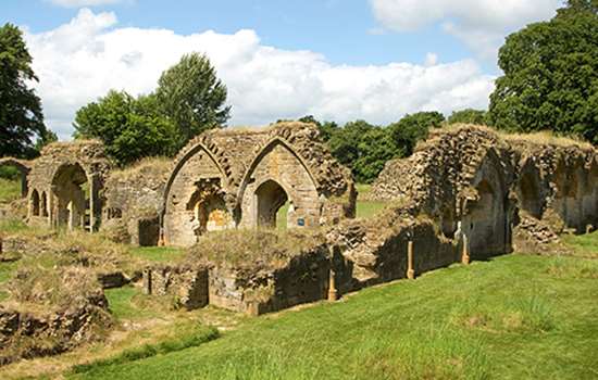 The ruins of an abbey surrounded by grass