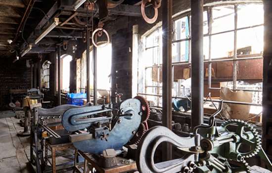 A view of a workshop in the J.W. Evans Silver factory with large windows.