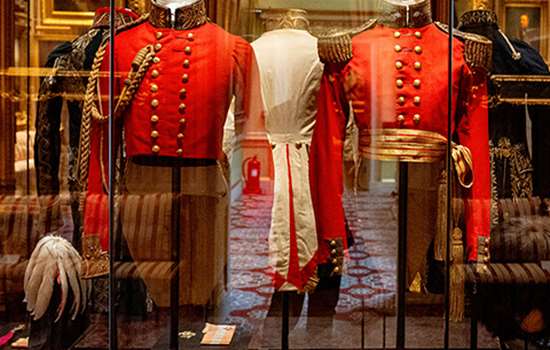 Red Georgian military costumes in a glass case