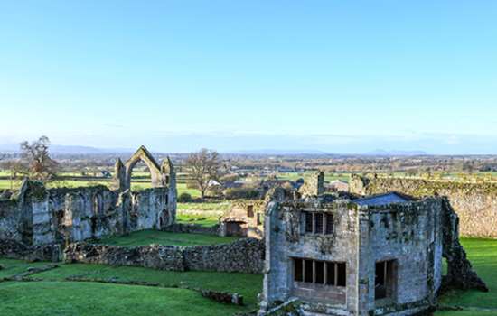 A high angle view of Haughmond Abbey ruins on a sunny day.